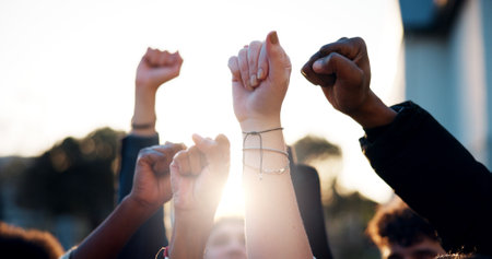 Hands, fist and students with protest outdoor for education riot, university equality and change law. Group, people and power with call to action for free learning, society support and racism justiceの写真素材