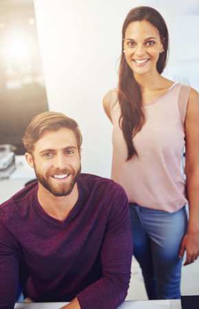 Architect, man and woman with smile at office with documents, blueprint and pride for career at company. People, partner and happy with floor plan, property and creativity for real estate in Spainの写真素材