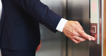 Hands, business person and press elevator, transport technology and arrow to request down floor. Office, call lift and push button for travel, work trip and level choice in corporate hotel lobbyの写真素材