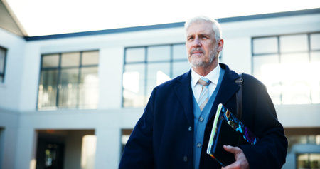 Mature man, teacher and walking at school with books for lesson, start teaching and education...