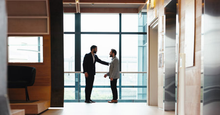 Collaboration, conversation and meeting with business people at window in office for partnership....