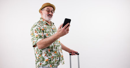 Travel, mature man and phone with suitcase, vacation and research for hotel, reading online review and studio. Senior person, retirement and holiday planning for hospitality, luggage and lodge tripの写真素材