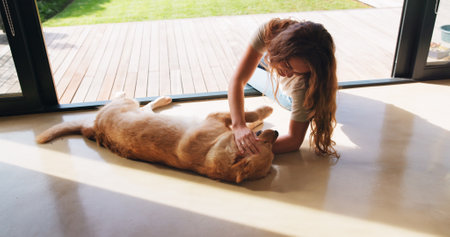 Bonding, petting or playing with woman and dog on floor of home together for love, loyalty or trust. Affection, companion or cuddle with pet owner and labrador retriever in apartment for fun or gamesの写真素材