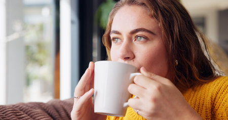 Thinking, cozy and woman with coffee, home and calm with beverage in living room, relax and break....