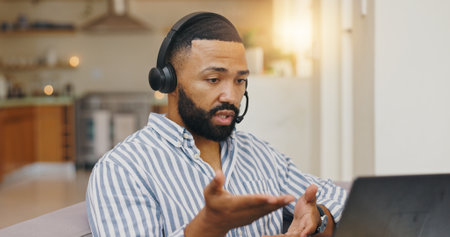 Remote work from home, video call and man with laptop, conversation and communication. Person, employee and freelancer with feedback, computer and proposal for creative project and talking with ideasの写真素材