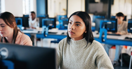 Girl, student and listening with computer in classroom for lecture, education or learning at IT...