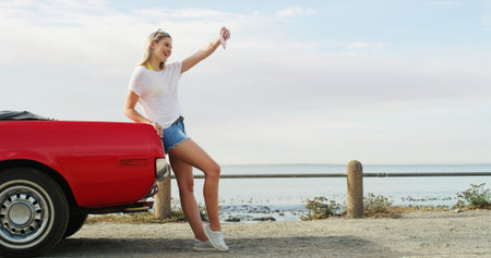 Road trip, girl and selfie with car for vacation, travel and holiday outdoor by ocean. Convertible...