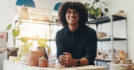 Pottery portrait, man and smile in small business for product manufacturing, ceramics workshop and creative store. Production, person and happy for sculpture handicraft, management and confidenceの写真素材