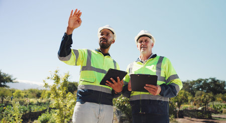 Outdoor, architecture or business people with tablet for construction, project development or...
