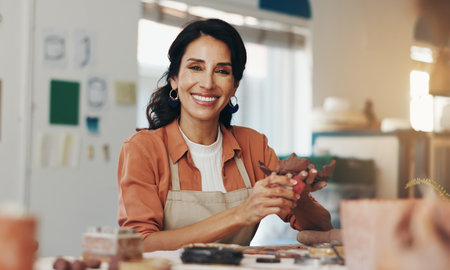 Woman, portrait and pottery in clay studio, workshop and art process for handmade ceramic design. Craft, hobby and happy artist with fun, artwork and smile in creative class for sculpture learningの写真素材
