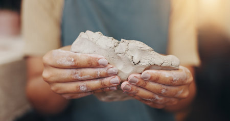 Pottery, hobby and hands of person in studio for sculpture, manufacturing and artist workshop....