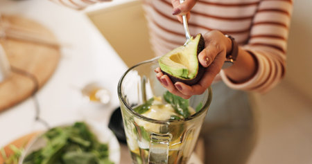 Woman, kitchen or hands with avocado in blender for fruit smoothie, breakfast drink or digestive...
