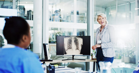 Doctor, surgeon and coaching with screen for x ray, medical procedure or CT scan results at office....