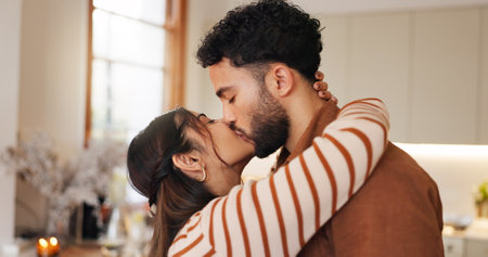 Couple, date and kiss in home embrace, valentines day and trust in relationship. Partnership, romance and support husband with commitment in love, bonding and sweet moment of affection in marriageの写真素材