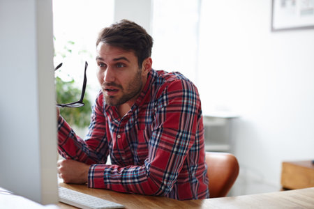 Business, shocked and man in office, pc and online reading with announcement. Person, creative...