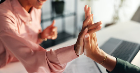 High five, success and teamwork with hands of business people for solidarity, profit bonus and achievement. Celebration, meeting and partnership with closeup of employees in office for supportの写真素材