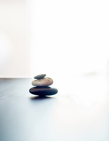 Spa, balance and stones for beauty, wellness and treatment with heat for deep tissue massage. Salon aesthetic, mockup space and hot rocks for health, muscle tension and detox for stress reliefの写真素材