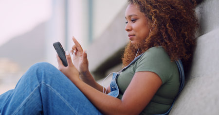 Phone, relax and woman in city scrolling online for celebrity news, update or review on mobile app. Technology, reading and female person browsing on website for gossip blog with cellphone in town.の写真素材