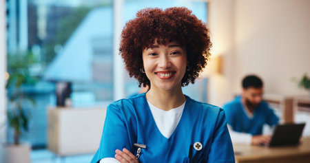 Healthcare, nurse and portrait in hospital with confidence, pride and public service with smile. Woman, medical assistant and arms crossed in clinic with experience, about us and friendly attitudeの写真素材