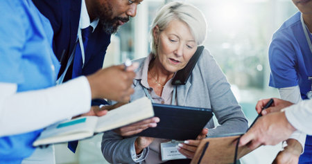 Mature woman, director and multitasking with medical team for overworked pressure or chaos at busy...
