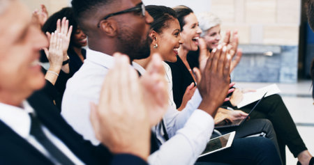Happy, business people and seminar with applause in row for presentation, meeting or speech at office. Excited, group or employees clapping with smile for staff training, workshop or work conferenceの写真素材