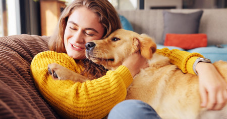 Home, hug and woman with dog, relax and bonding together with happiness, comfort and carefree. Apartment, pet and person on sofa, best friend and domestic animal with embrace or playing in loungeの写真素材