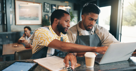 Laptop, checklist and planning with people in cafe for product inventory, supplier contact or budget discussion. Menu discount, restaurant and small business owner with employee in coffee shopの写真素材