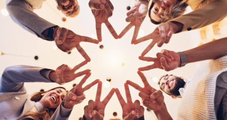 Happy, business people or meeting with finger star below for unity, motivation or teamwork at...
