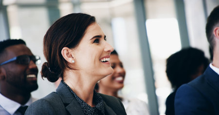 Smile, group and business people at seminar with attention for corporate training, development or teamwork. Audience, men and women at conference for presentation, planning and opportunity for growthの写真素材