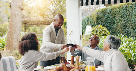 Family, toast and outdoor dining table for celebration on vacation, easter lunch and proud to...