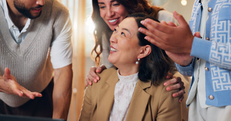 Excited business woman, winner and congratulations in promotion, announcement or office negotiation success. Group of employees, clapping or applause for partnership, prize or workplace contract goalの写真素材