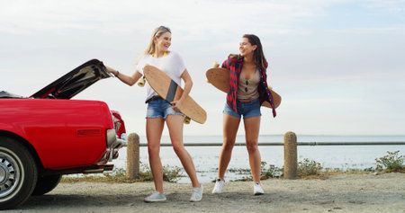 Ocean, skateboard and women with car, smile and bonding together with tourism, vacation and explore....