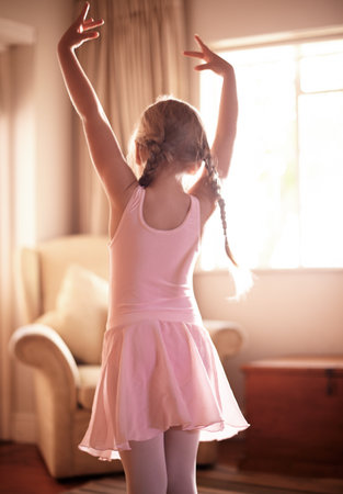House, ballet and girl with energy, back and growth with pink tutu, movement and practice. Learning, ballerina or kid with costume, training for performance or creativity with routine and dancingの写真素材