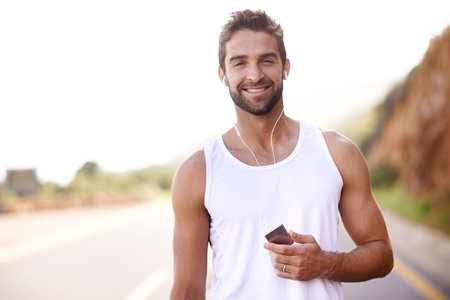 Fitness, portrait and man on road with earphones, confidence and audio tech on morning workout....