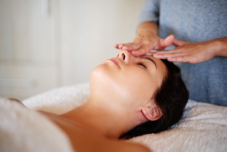 Massage, woman face and masseuse with hands at spa, beauty treatment and holistic healing with skincare. Therapy, luxury resort and client pressure at salon, cosmetic service and smooth or soft skinの写真素材