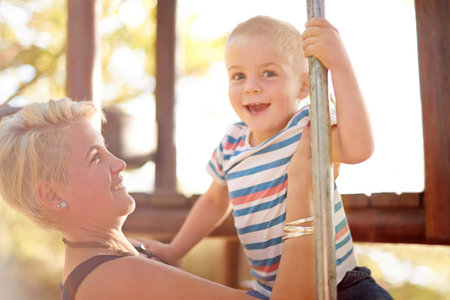 Happy, playground and mom with child in park for playing, childhood and adventure outdoors. Nature, family and portrait of mother with boy for bonding, learning skills and development on jungle gymの写真素材