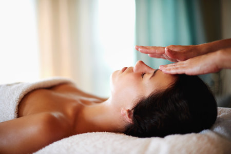 Massage, facial and woman for therapy at spa, beauty treatment and holistic healing with skincare. Masseuse hands, luxury resort and client pressure at salon, cosmetic service and smooth or soft skinの写真素材