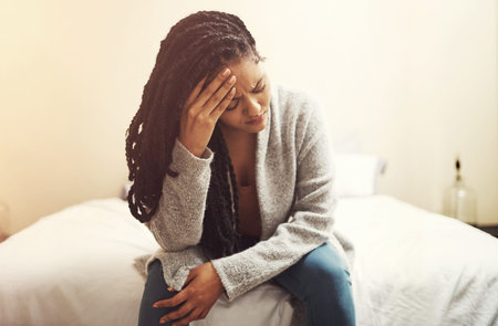 Woman, stress and depression on bed, home and headache with financial crisis, rent or mortgage....