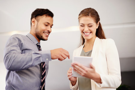 Tablet, team and happy business people in discussion, talking and solution in office. Cooperation, technology and worker planning with financial manager for schedule, sales or budget cost in meetingの写真素材