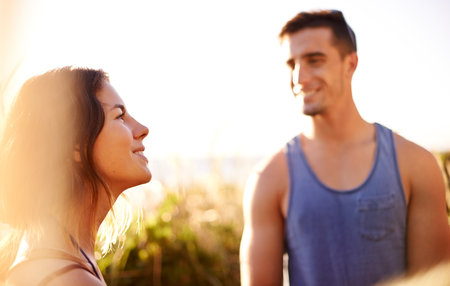 Smile, couple and hiking on mountain outdoor for date adventure, travel journey and exploration. Happy, people and view with trekking getaway, sightseeing and vacation trip for bonding at destinationの写真素材