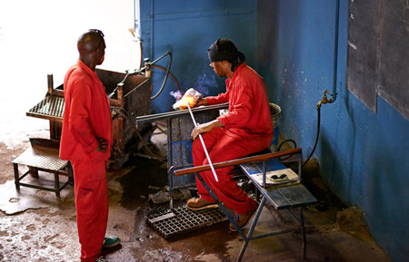 Glassblowers, industry or people in workshop with heating equipment, professional craft or...