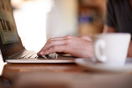 Laptop, hands typing and person in coffee shop, digital nomad or remote work for social media...