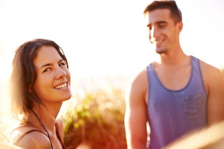 Happy, couple and hiking on mountain outdoor for date adventure, travel journey and exploration. Smile, people and view with trekking getaway, sightseeing and vacation trip for bonding at destinationの写真素材