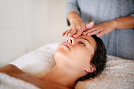 Massage, facial and face of woman at spa for skincare, beauty and treatment at luxury resort. Salon aesthetic, dermatology and person with masseuse for wellness, cosmetics service and detox therapyの写真素材