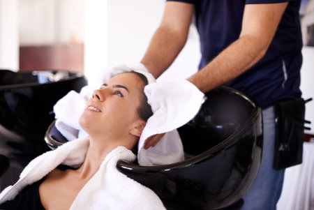Towel, woman or hands of hairdresser in salon for drying scalp, healthy head or cleaning treatment. Spa appointment, stylist and grooming service for client, girl and shampoo cosmetics for beautyの写真素材