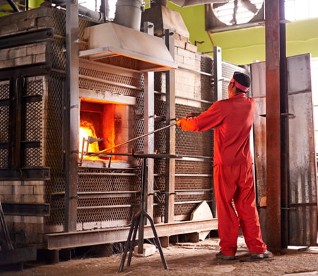 Glass factory, man and fire in furnace for production process, manufacturing and back in industry....
