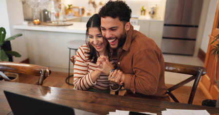 Couple, laptop and hug for success in home, reading loan application response and support with win. Happy people, embrace husband and email announcement for mortgage insurance, celebrate and loveの写真素材