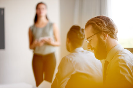 Business people, listening and meeting with presentation at workshop for staff training or collaboration at office. Group, audience or employees with speaker talking for team delegation at seminarの写真素材