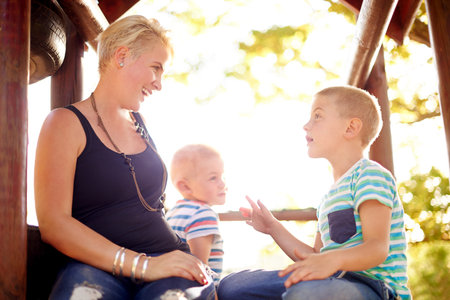 Jungle gym, mother and brothers in playground, talking and relax with happiness, funny and family. Single parent, mama and boys in park, nature and bonding together with fun, laughing and countrysideの写真素材