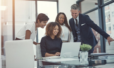 Laptop, research or happy business people in meeting with news for feedback, discussion or teamwork. Budget report, finance or excited financial advisor with economists for economy or collaborationの写真素材